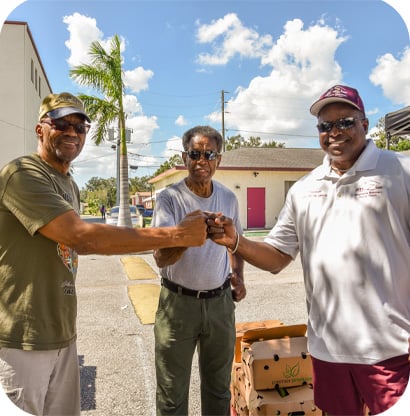 three men fist bumping