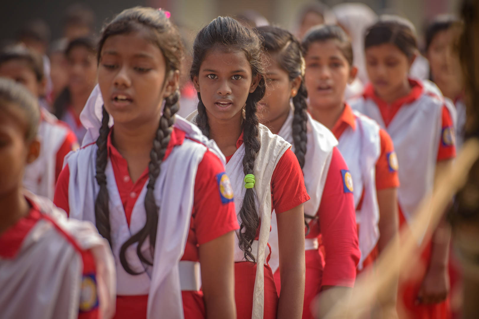 Bristy (center) and her classmates exercise in the school courtyard.