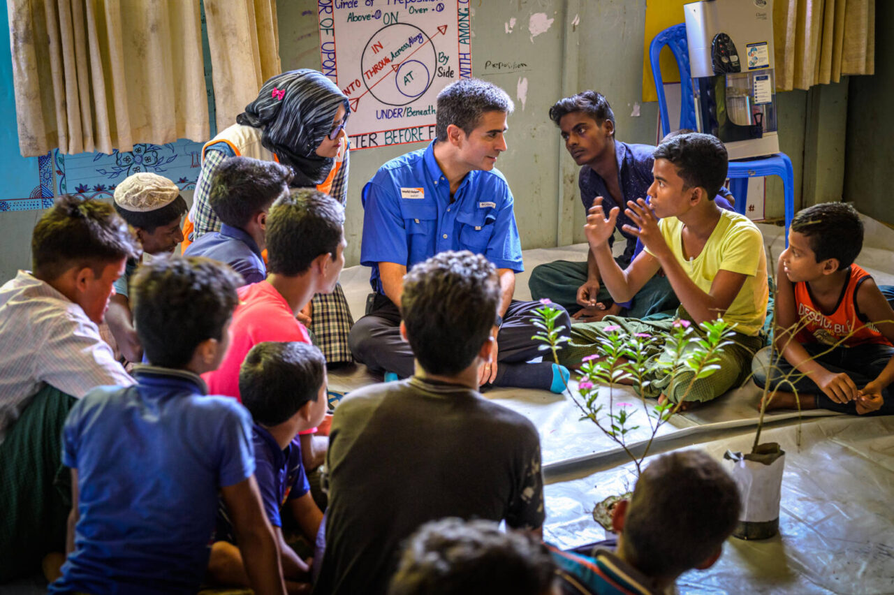 World Vision U.S. President and CEO Edgar Sandoval Sr. listens to a teenage boy share his story at a vocational training center in a Rohingya refugee camp in Cox&rsquo;s Bazar, Bangladesh.Oka