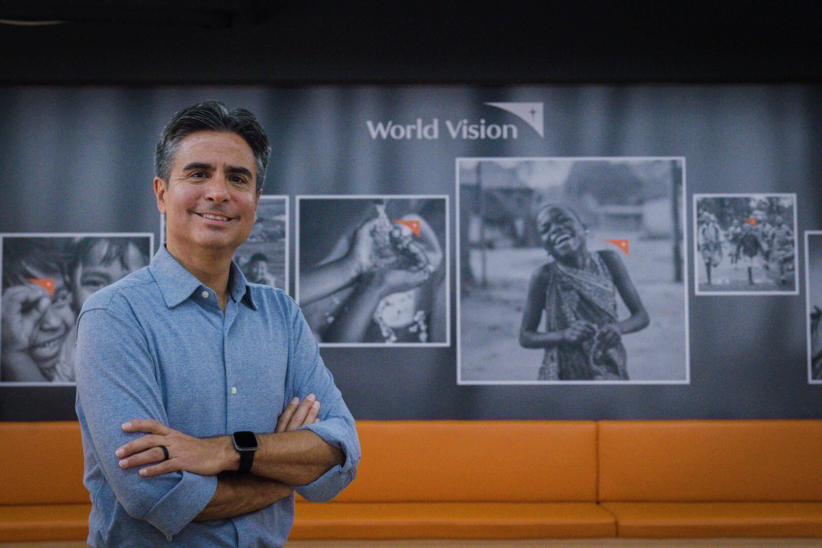 edgar standing next to world vision images