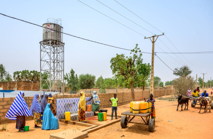 Women and men fill water containers from a water source in Niger, one of the worst countries for access to clean water.
