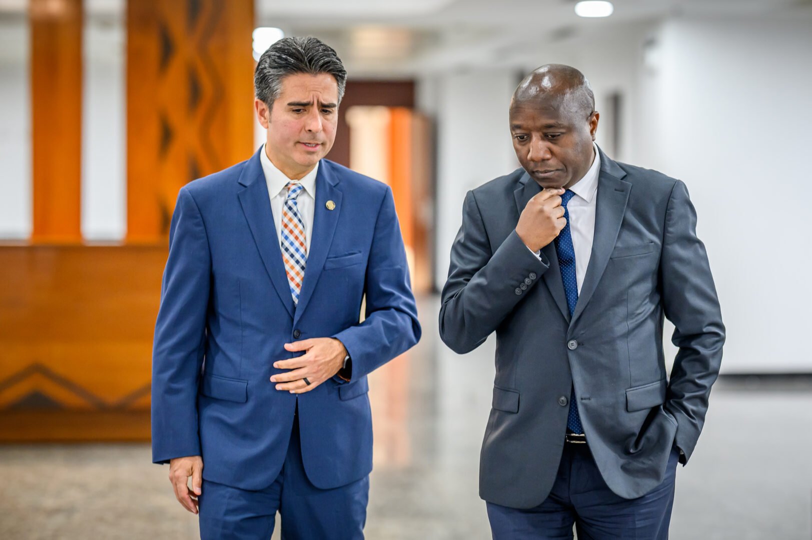 edgar walking and talking with another man