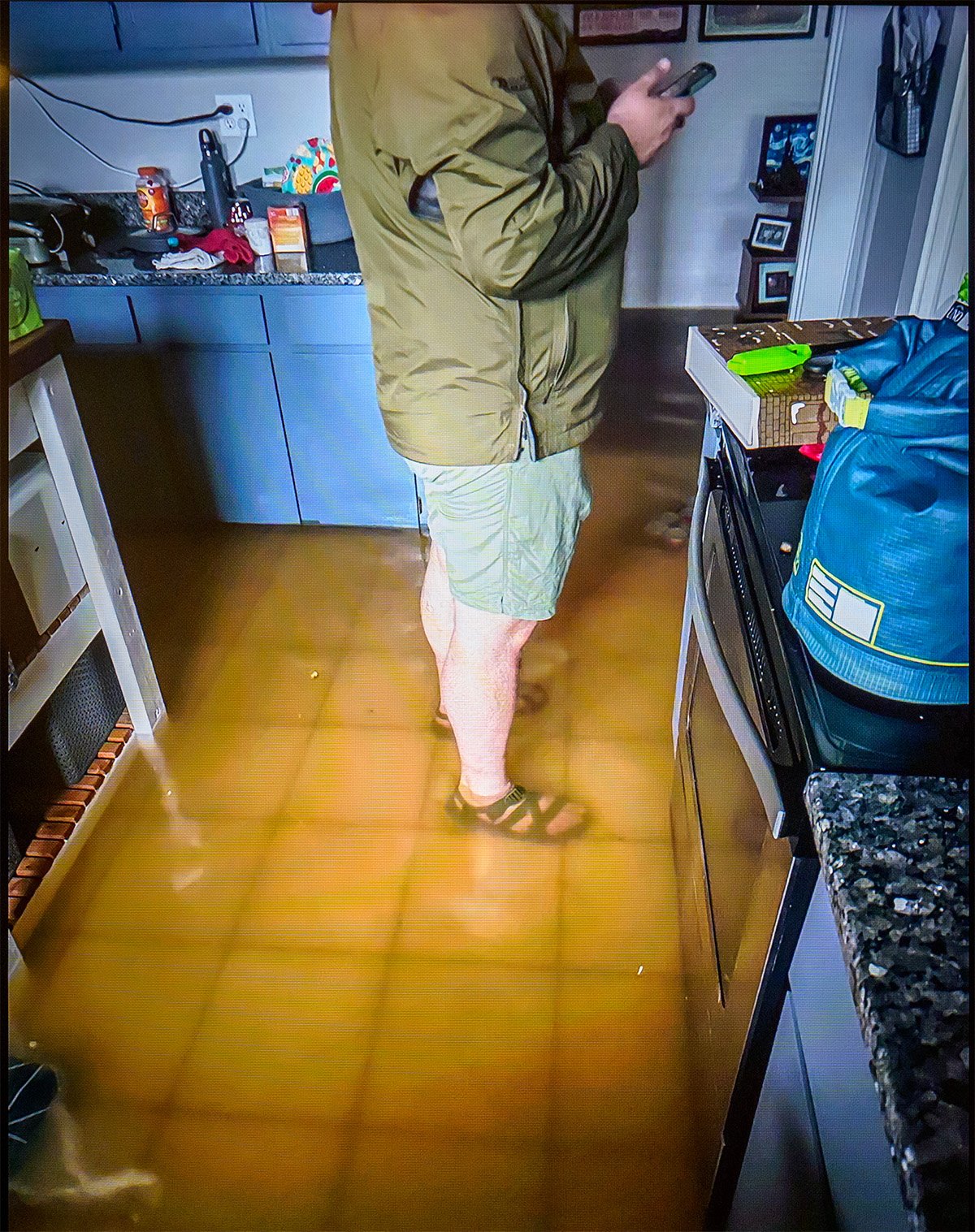 man standingi n flooded home