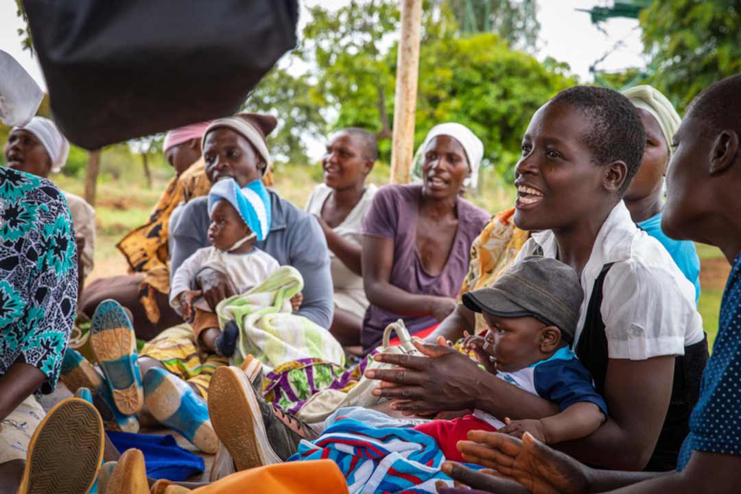 A woman sings at a care group meeting in Zimbabwe.