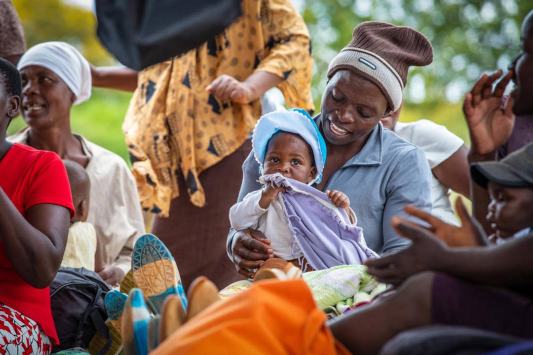 Woman holds her baby