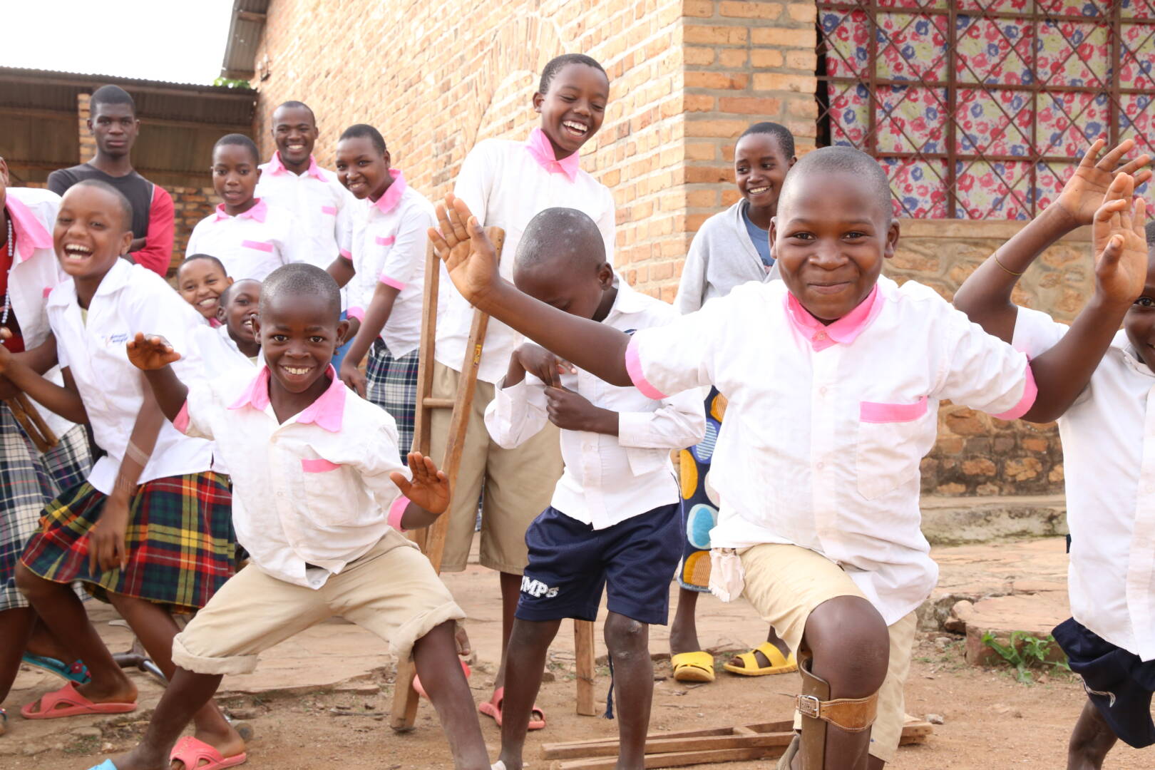 Children spread their arms, drop their crutches, and dance in a joyous celebration.