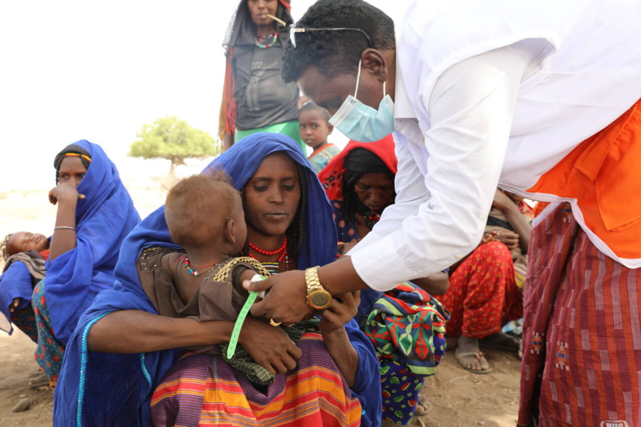 Aid worker screens Assiya Ali&rsquo;s child for malnutrition at a World Vision-supported mobile health clinic in northern Ethiopia.