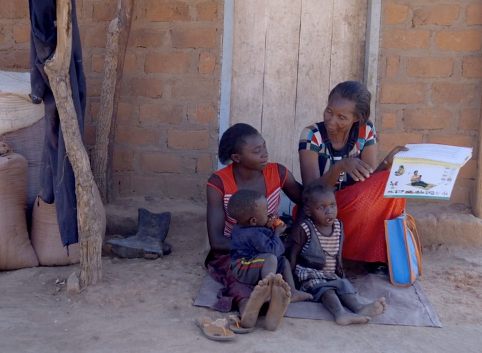 Doreen and her children listen as Rhoda, a community health worker, educates them about better health practices in Zambia.